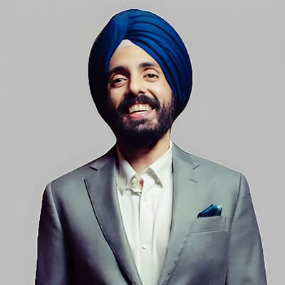 A headshot of Brijinder Anand. He is smiling at the camera.